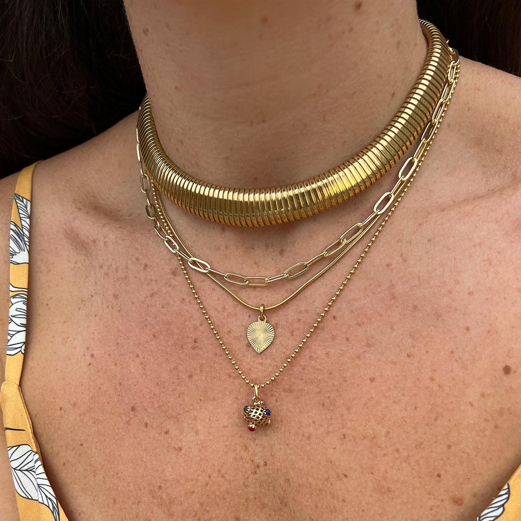 Layered necklaces on a model featuring Lico Jewelry vintage 18K tubogas necklace