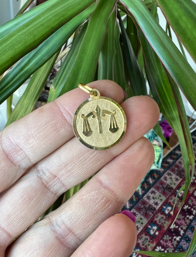 Lico Jewelry vintage 18K Libra medallion - front view with green plant background