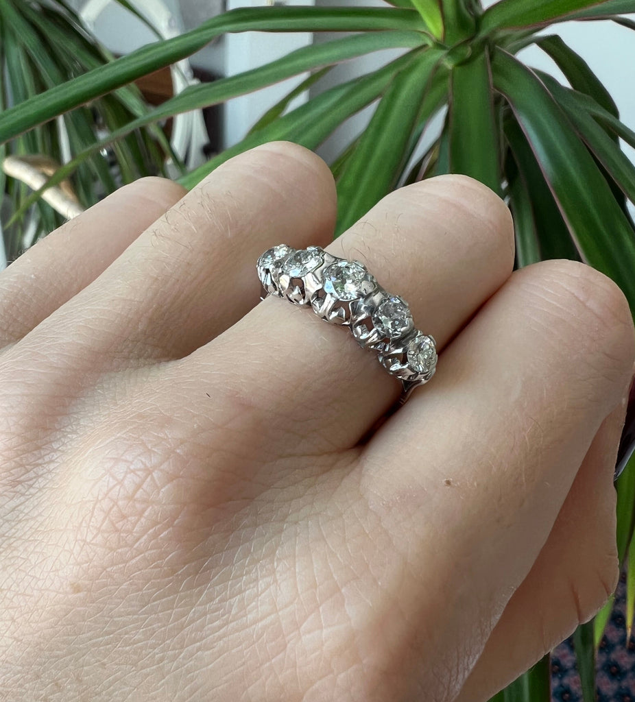 Lico Jewelry Montreal - Vintage 18k diamond ring on hand with bent fingers and green plant in background