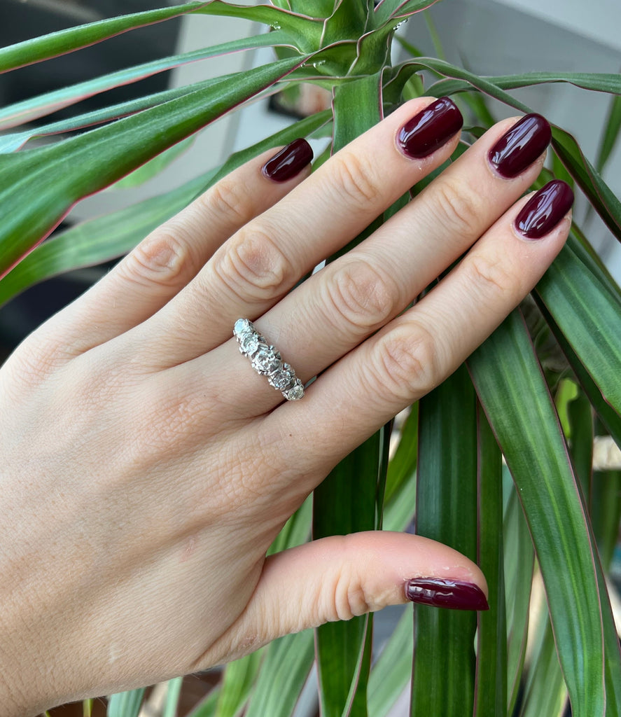Lico Jewelry Montreal - Vintage 18k diamond ring on hand with burgundy nail polish on middle finger, fingers straightened out