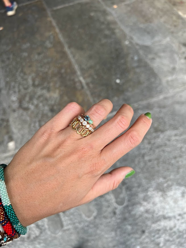 London lime rin stacked with Lico Jewelry rings on woman's finger with green nail polish
