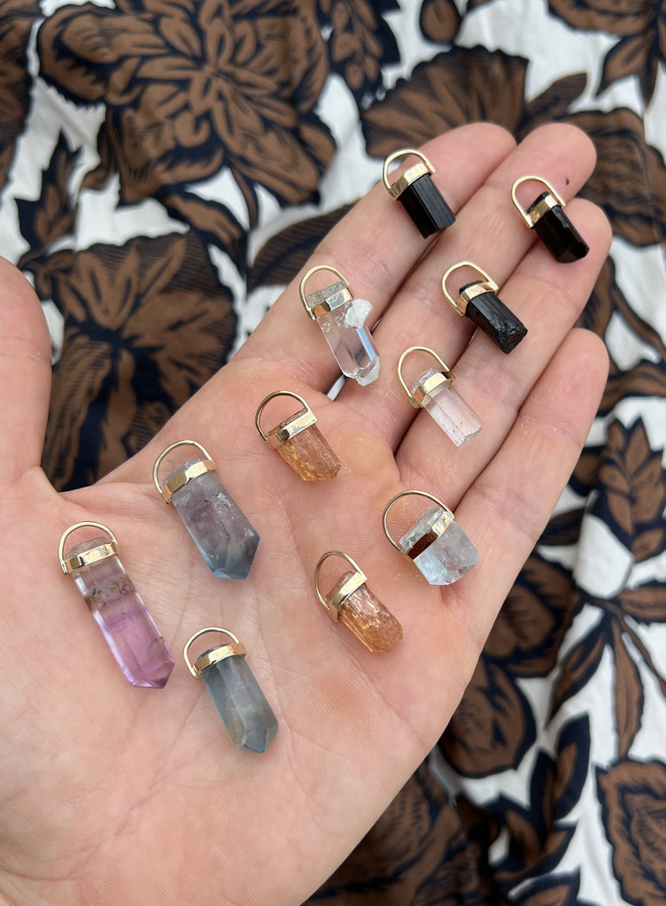Handcrafted Fluorite Crystal Pendants by Lico Jewelry, based in Montreal, featuring genuine fluorite crystals in shades of green, lilac and a hint of brown, perfect for layering and creating a unique look.