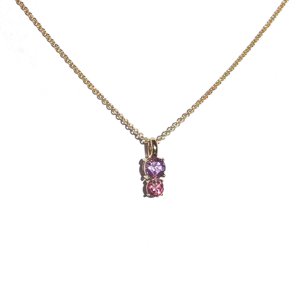 A close-up of Lico Jewelry's Doll House pendant made with solid 14k yellow gold, 0.40 ct genuine rose de france amethyst, and 0.25 ct genuine pink tourmaline, based out of Montreal.