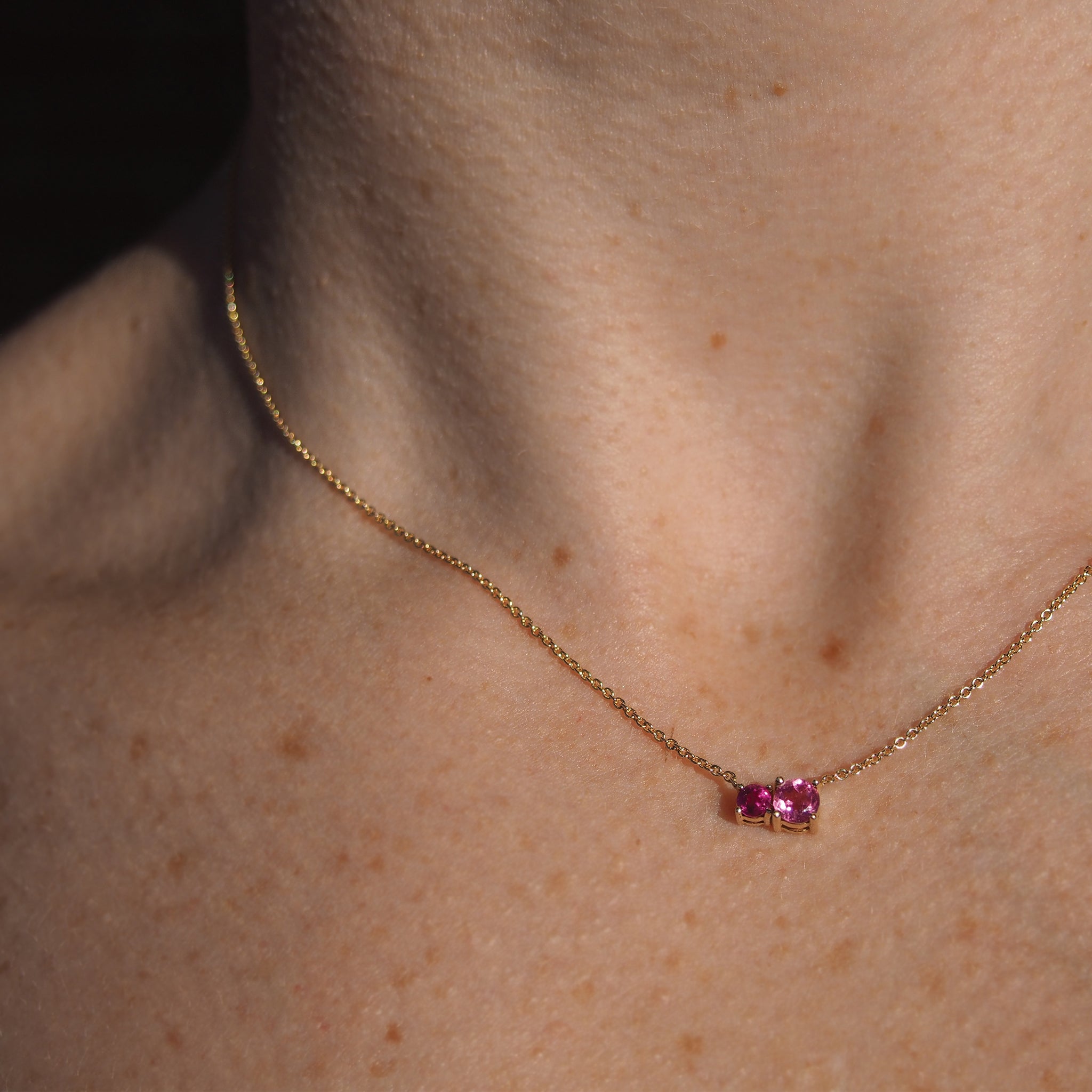 Perfectly aligned stack of Lico Jewelry's 2 stone necklace in solid 14k yellow gold, featuring genuine pink tourmaline and rubelite, and other necklaces. All made by Lico Jewelry in Montreal.