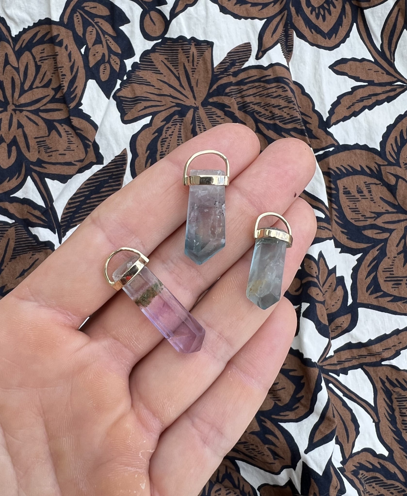 Lico Jewelry's Fluorite Crystal Pendants, handcrafted in Montreal with genuine fluorite crystals in shades of green, lilac and a hint of brown, each pendant is unique.