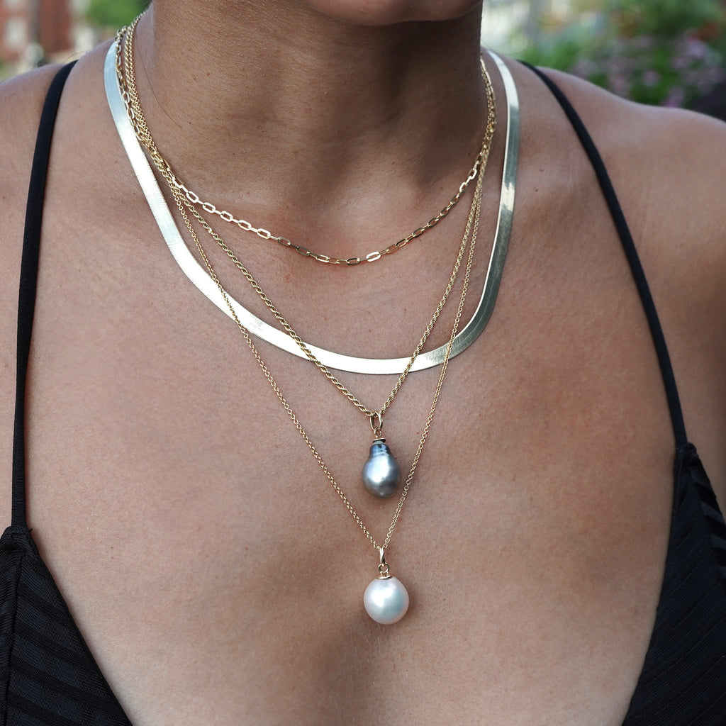 Layered look with a solid 10k yellow gold herringbone chain from Lico Jewelry, based in Montreal, paired with other necklaces.