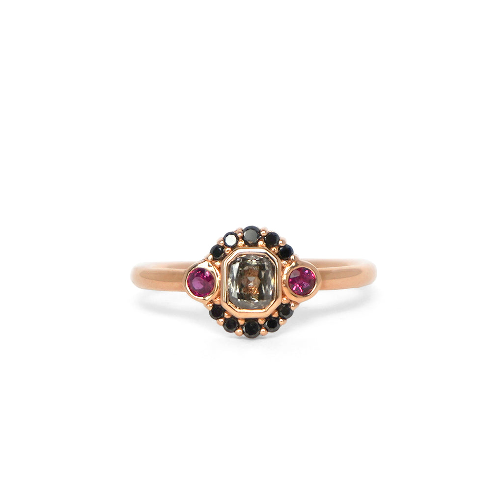 La Couche du Diable ring from Lico Jewelry in Montreal, featuring a unique salt and pepper diamond surrounded by black diamonds and rubies set in 18k rose gold
