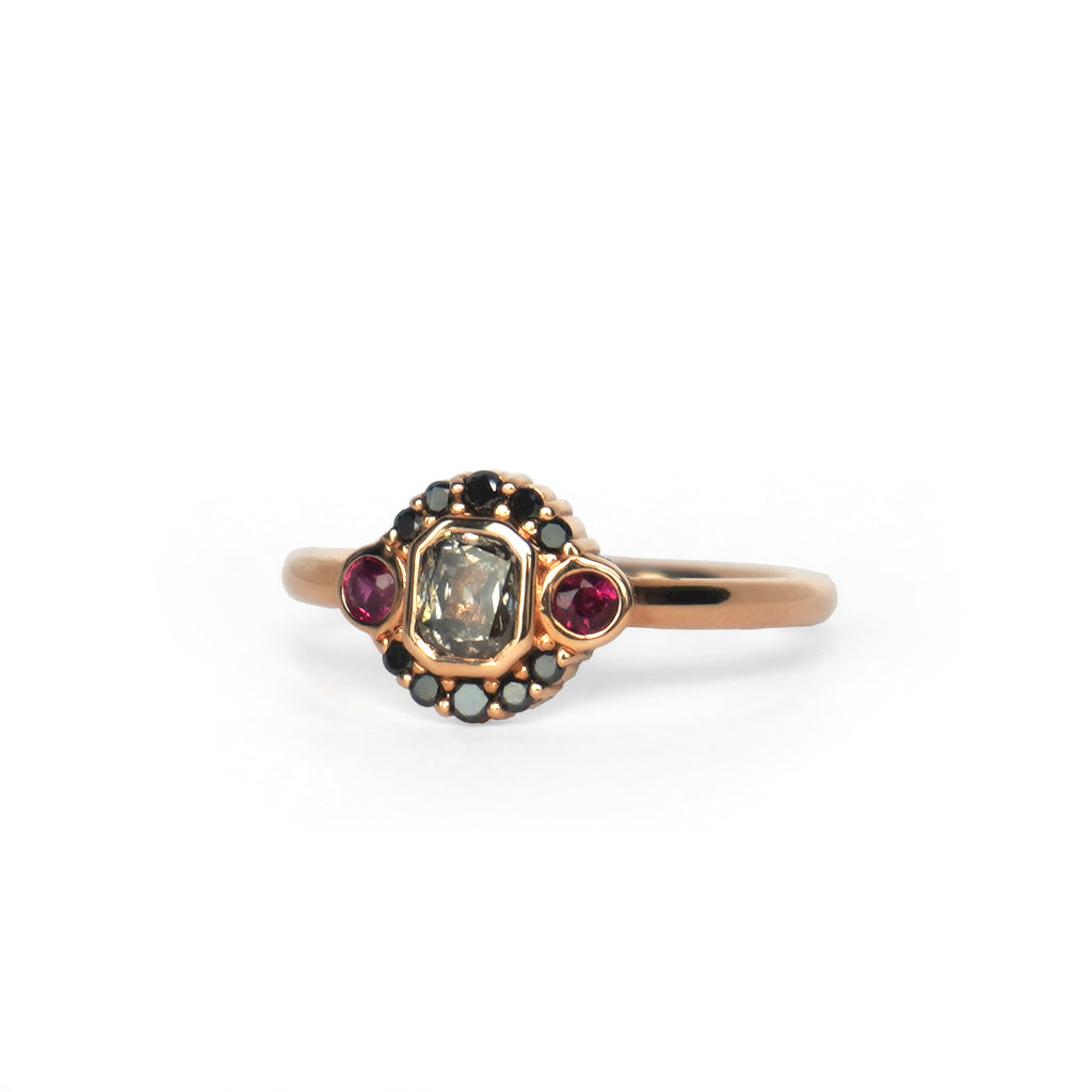 La Couche du Diable ring from Lico Jewelry in Montreal, featuring a unique salt and pepper diamond surrounded by black diamonds and rubies set in 18k rose gold