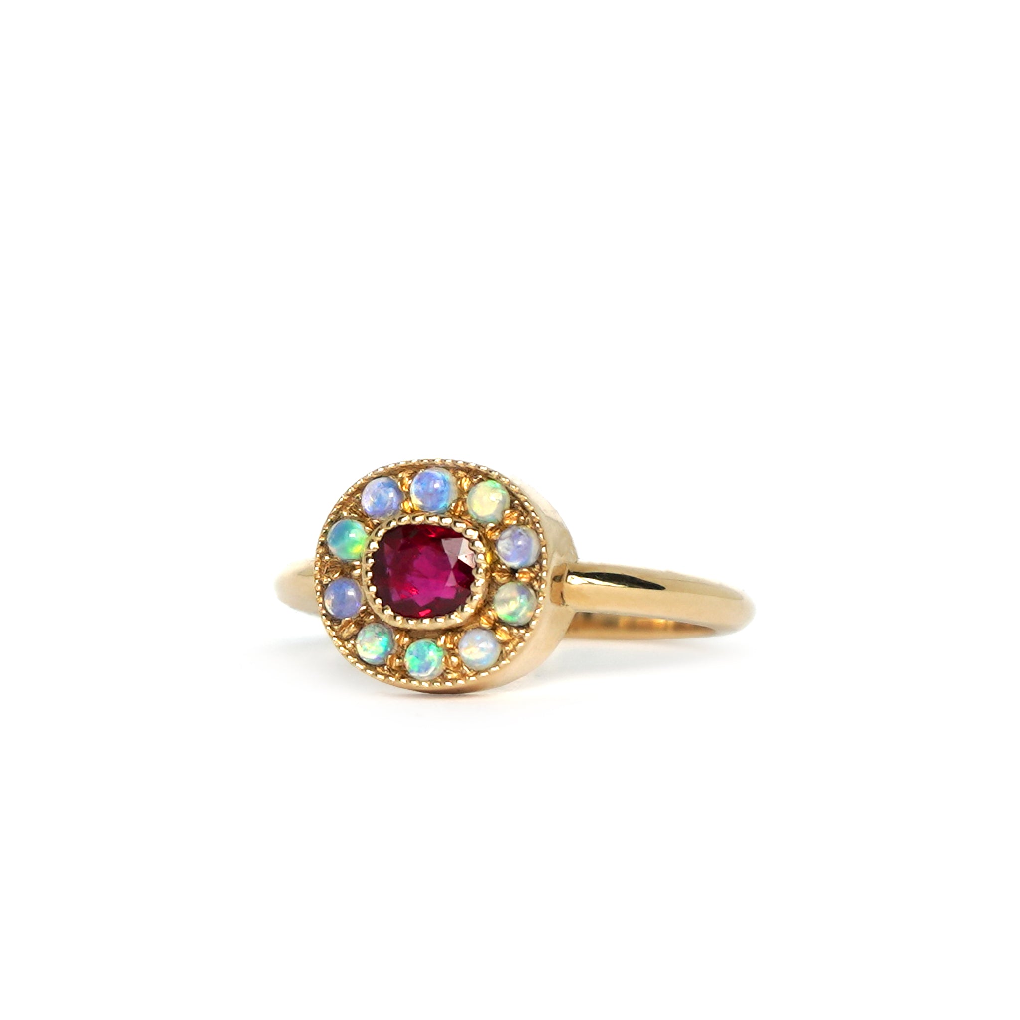 Close-up view of the one-of-a-kind Ruby halo ring with mini Australian opals, retro-antique inspired design by Lico Jewelry, set in solid 14k yellow gold, shown in ring size 8.