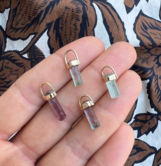 Woman holding four tourmaline crystal pendants, colors and sizes may vary, Lico Jewelry